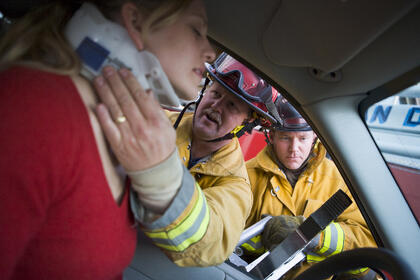 Woman injured in a car accident with rescue personnel