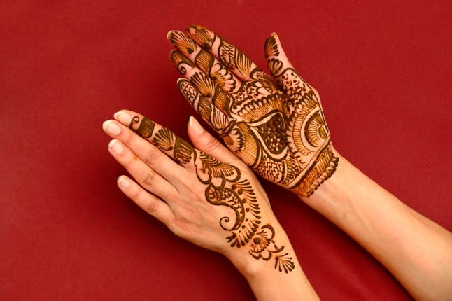 Henna designs painted on woman's hands