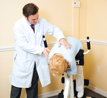 Woman receiving chiropractic care after injury