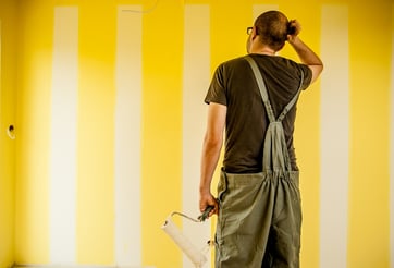 painter working scratching head