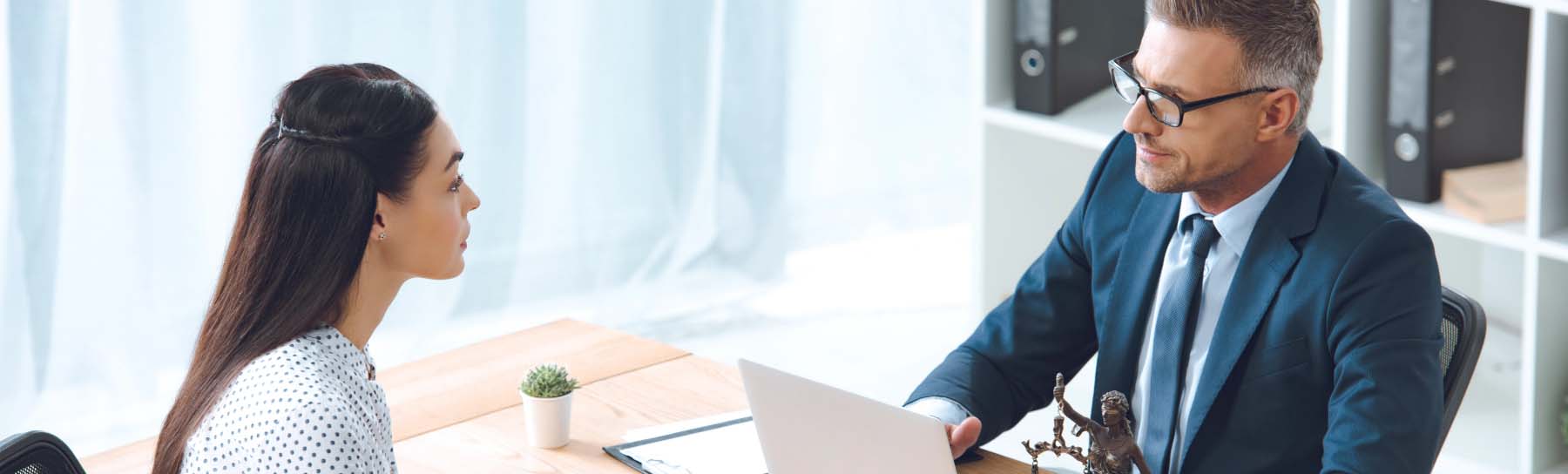 young woman and businessman holding meeting