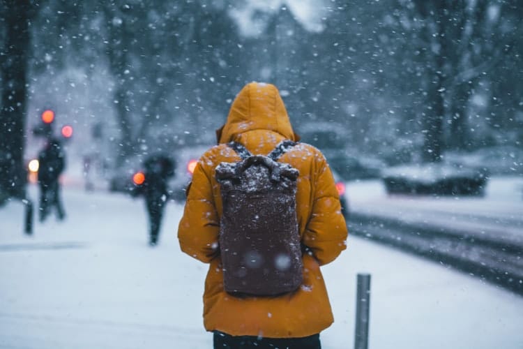 person-in-yellow-jacket-walking-in-snow